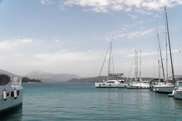 Fototapeta na wymiar Aegina Island of Greece. Yachts of fishing village. Sky and sea, hills. Mediterranean sea