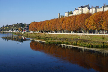 Fototapeta premium mirror reflection of the fortress and town of Chinon, France in the river Vienne on a perfect blue day in the fall