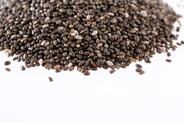 Small group of chia seeds isolated on white background. Closeup. Top view. Chia super food.