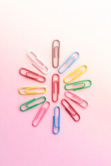 paper clips on a pastel background. The idea for the design of school notebooks.