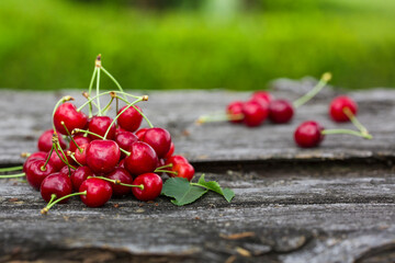Fresh cherry on an old wooden board.