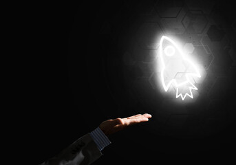 Man palm presenting Rocket web icon as technology concept