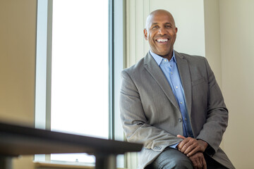 Happy mature African American man at work.