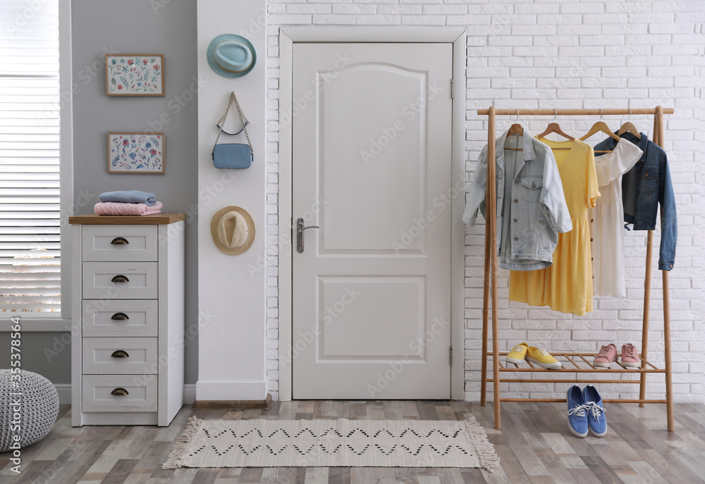 Poster Hallway interior with stylish furniture, clothes and accessories