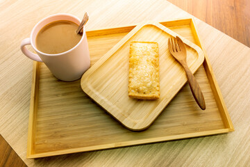 Hot coffee and pies on a wooden tray