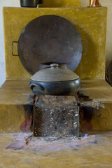 old wood oven with iron pots on top