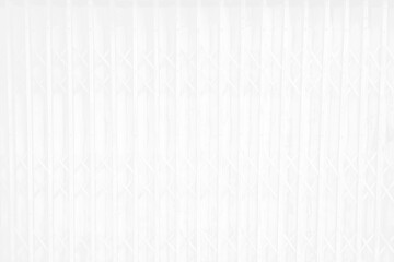 Old folded steel door, the white surface gives an old and beautiful feeling. Soft white vertical metal door surface is an old gray white iron wall. Abstract for the background.