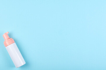 Hand sanitizer bottle on blue background.