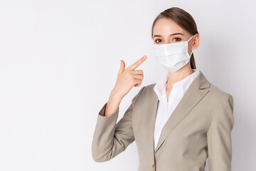 Beautiful woman with light brown suit and wearing mask
