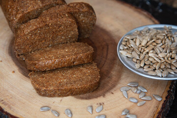 Homemade sunflower halva sliced on wooden background