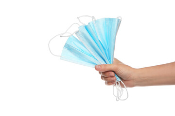 Woman holding disposable face masks on white background, closeup. Protective measures during...