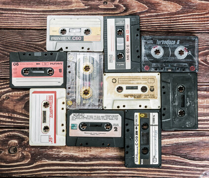 Moscow, RUSSIA - May 24, 2016: Old Cassette tapes over textured wooden table. Cassette tapes of different firms Maxell, Sakura, Svema etc.