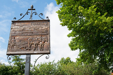 Old wooden village sign of Firbeck, Rotherham, South Yorkshire, England.