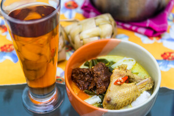 Indonesian traditional food ketupat sayur  served at home table