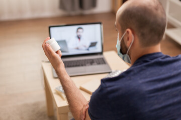 Ill patient in video call with doctor talking about his treatment during quarantine.