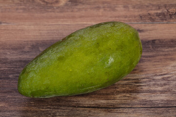 Green tasty mango over wooden background