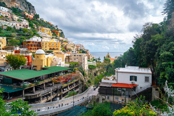 Fototapeta na wymiar Beautiful colorful houses on a mountain in Positano, a town on Amalfi coast