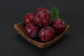 Plum heap in the wooden basket