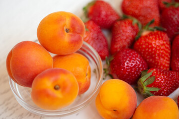 Naklejka na ściany i meble vase with apricots and fresh strawberries