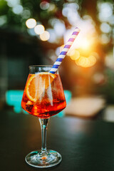 Glass of Aperol Spritz and blue straw, Italian Cocktail