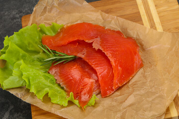 Sliced salmon fillet served rosemary