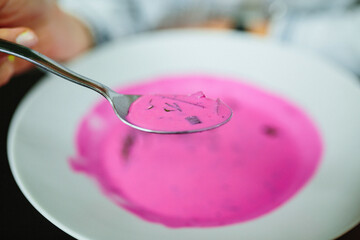 Cold beetroot soup. Focus on spoon.