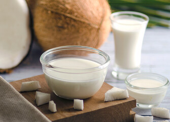 Pure Coconut Milk in Three Different Glass Containers. Close-up shot. in white background, with a depth of field, bokeh effect