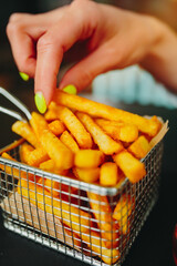 Basket of crispy French Fries on a cafe table