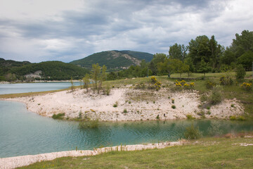 Fototapeta na wymiar View of Fiastra lake on cloudy day of summer in the Marche region