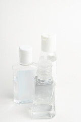 Obraz na płótnie Canvas Three Pocket-Size Transparent Hand Sanitizer Dispenser Plastic Bottles