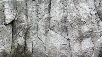 Stone rock texture or background. Gray rocky uneven surface, natural seamless backdrop for design. Copy space