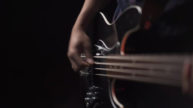 4K guitarist playing an electric bass guitar