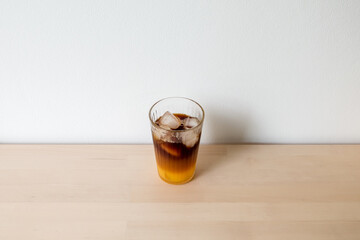 iced coffee with juice, homemade drink espresso shot mixed with orange juice for healthy drinking on wooden desk