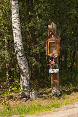 Przydrożna kapliczka z Matką Boską, stojąca pod lasem. - obrazy, fototapety, plakaty