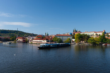 Fototapeta na wymiar Pleasure boat on the Vltava pier in the fall. View of Prague.