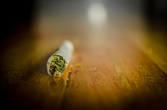 joint, cigarret rolled over wood