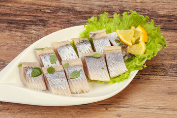 Herring fillet with sliced lemon