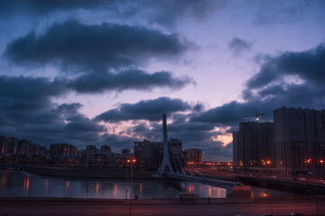 City buildings and bridge at dusk
