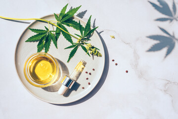Medical marijuana cannabis cbd oil. CBD oil hemp products. Macro detail of dropper with CBD oil, cannabis live resin extraction on white background. Medical marijuana concept