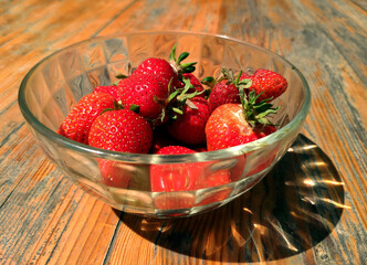 The first strawberry crop in a glass bowl