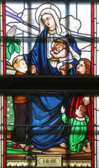 Obraz na płótnie Canvas Virgin Mary stained glass window in the church of St John the Baptist in Sveti Ivan Zabno, Croatia