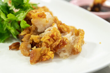 Crispy pork belly or deep fried pork with sweet sour sauce or black soya sauce.