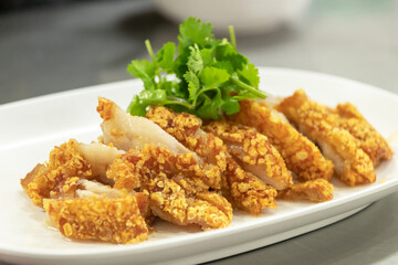 Crispy pork belly or deep fried pork with sweet sour sauce or black soya sauce.