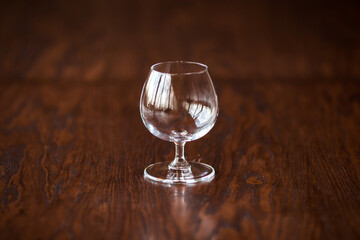 Elegant cognac glass on the dark wooden table