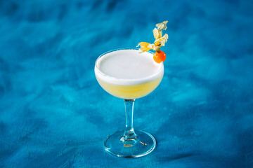 Whiskey sour physalis garnish in margarita glass