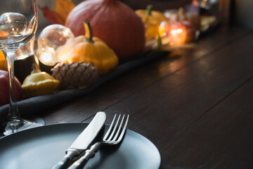 Fall dark place setting with pumpkins, autumn harvest. Thanksgiving Day. Close up.