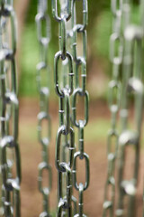 Metal chains are hanging. Abstract image, may be used as background.