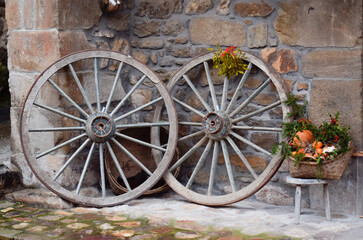 Old wheels of a carriage in an old stone town