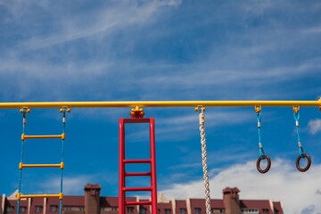 bright playground on the background of a brick house