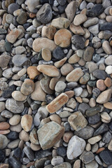 Rocks in a beach made of rocks of different sizes, colours and textures 